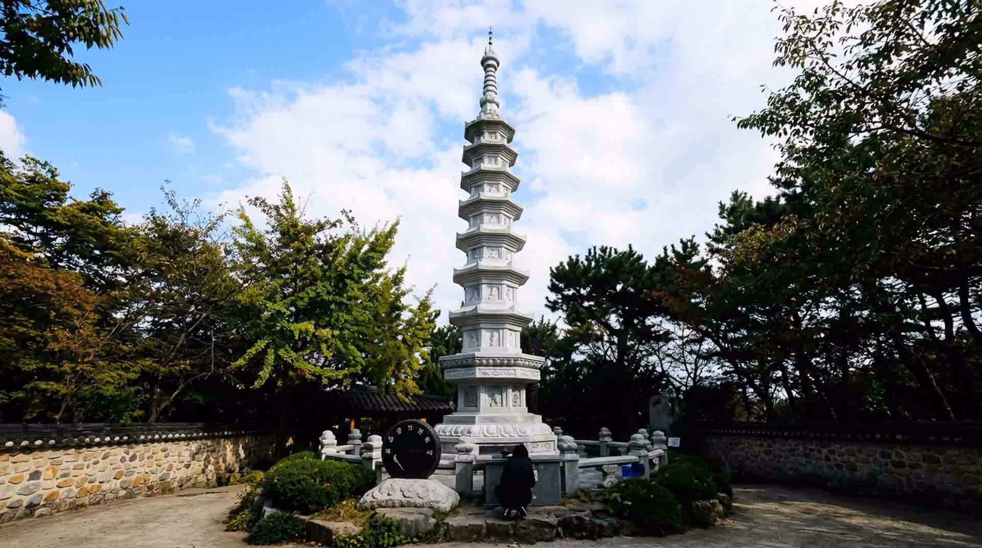 Stone pagoda at Haedong Yonggungsa Temple entrance (This image was partially enhanced/generated with AI for visual clarity)